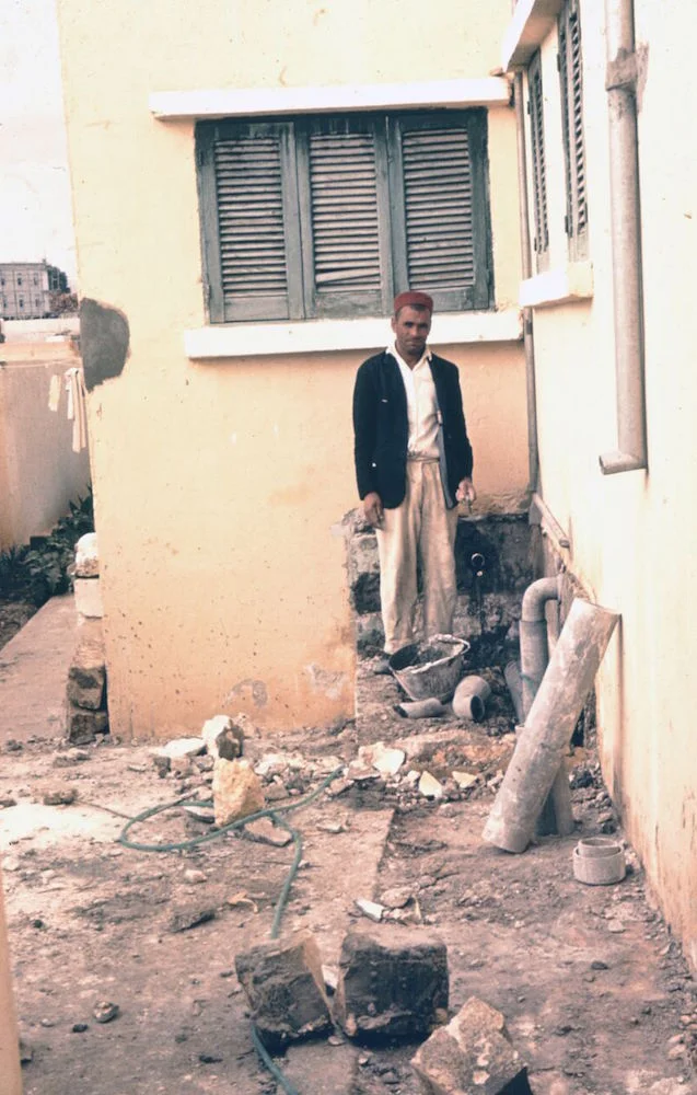 The replacement plumber standing, perplexed, outside the Naifehs' home in Baida.