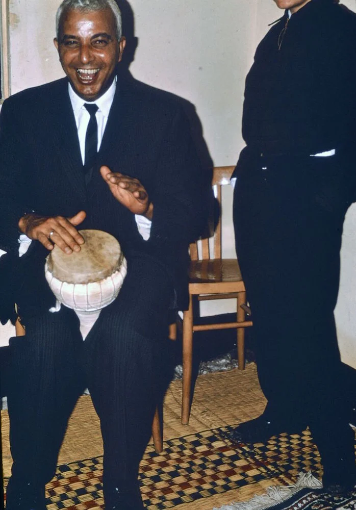 George playing a drum at a groom's party.