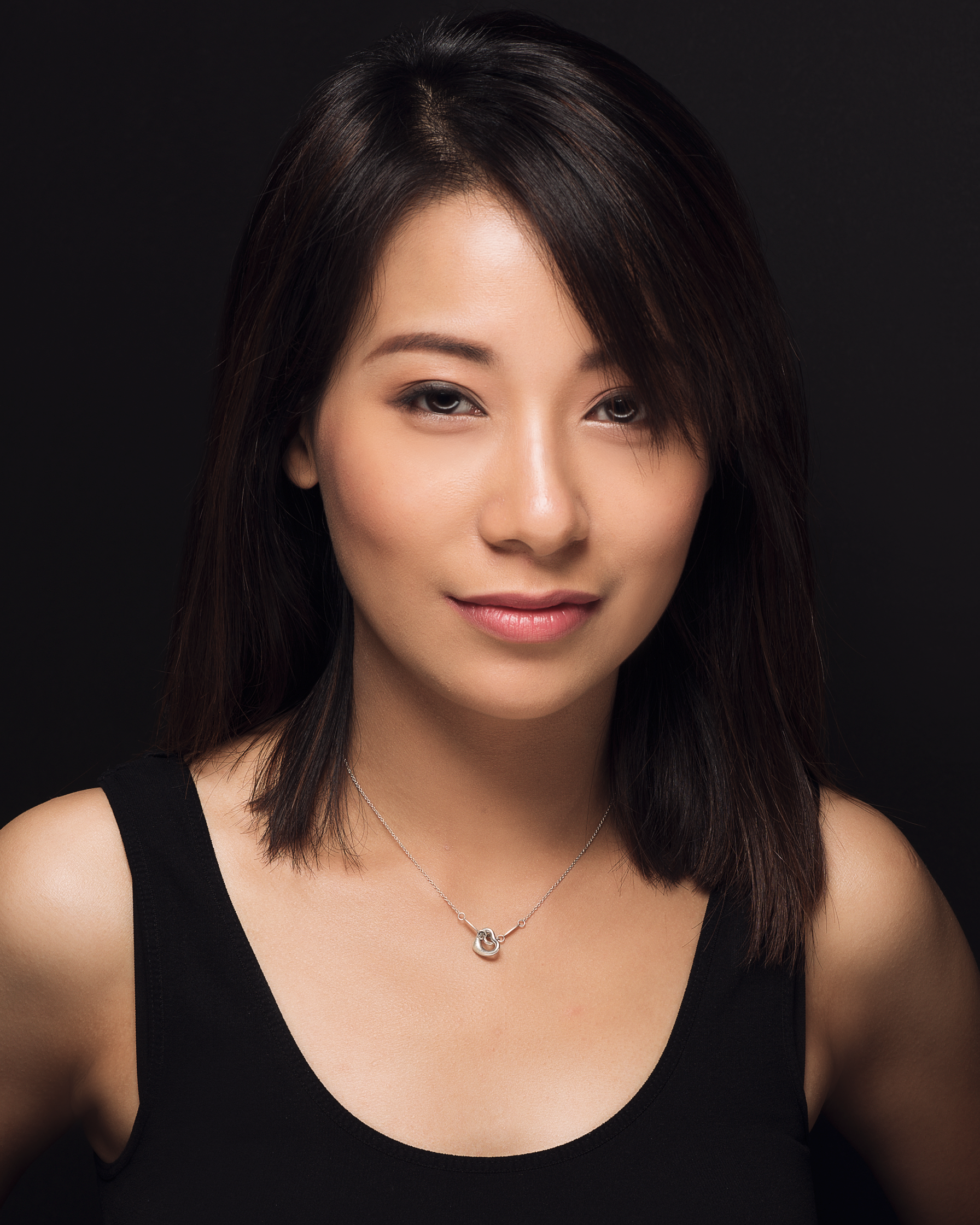 Annabel is a traveling Lawrence/Kansas City-based professional makeup artist. Born and raised in Hong Kong and having spent half her life in the US, Annabel keeps with the latest beauty and makeup trends and techniques in both Western and Asian cultures. Her philosophy for makeup artistry is significantly influenced by her training in vocal performance and the piano at an early age. At age 15, she spent time in Canterbury and London, England for a small production of Andrew Lloyd Webber’s musical Cats as Grizabella. She believes in harmony in her works of beauty; and harmony does not equal to dull and motionless. Harmony, to Annabel, can be loud, colorful and exciting, as long as the art piece does not become a sore to our senses. While she specializes in clean beauty makeup artistry, she does not limit herself from vibrant colors. She is a certified airbrush makeup artist and was a beauty consultant for Motives Cosmetics. Her work has been featured in local fashion shows, magazines and in a four-day concert at the Hong Kong Coliseum. She has assisted Celebrity Makeup Artist, Ms. Candace Corey, in an HGTV Christmas Commercial in 2011 and a beauty TV segment “Mirror, Mirror” in Texas.