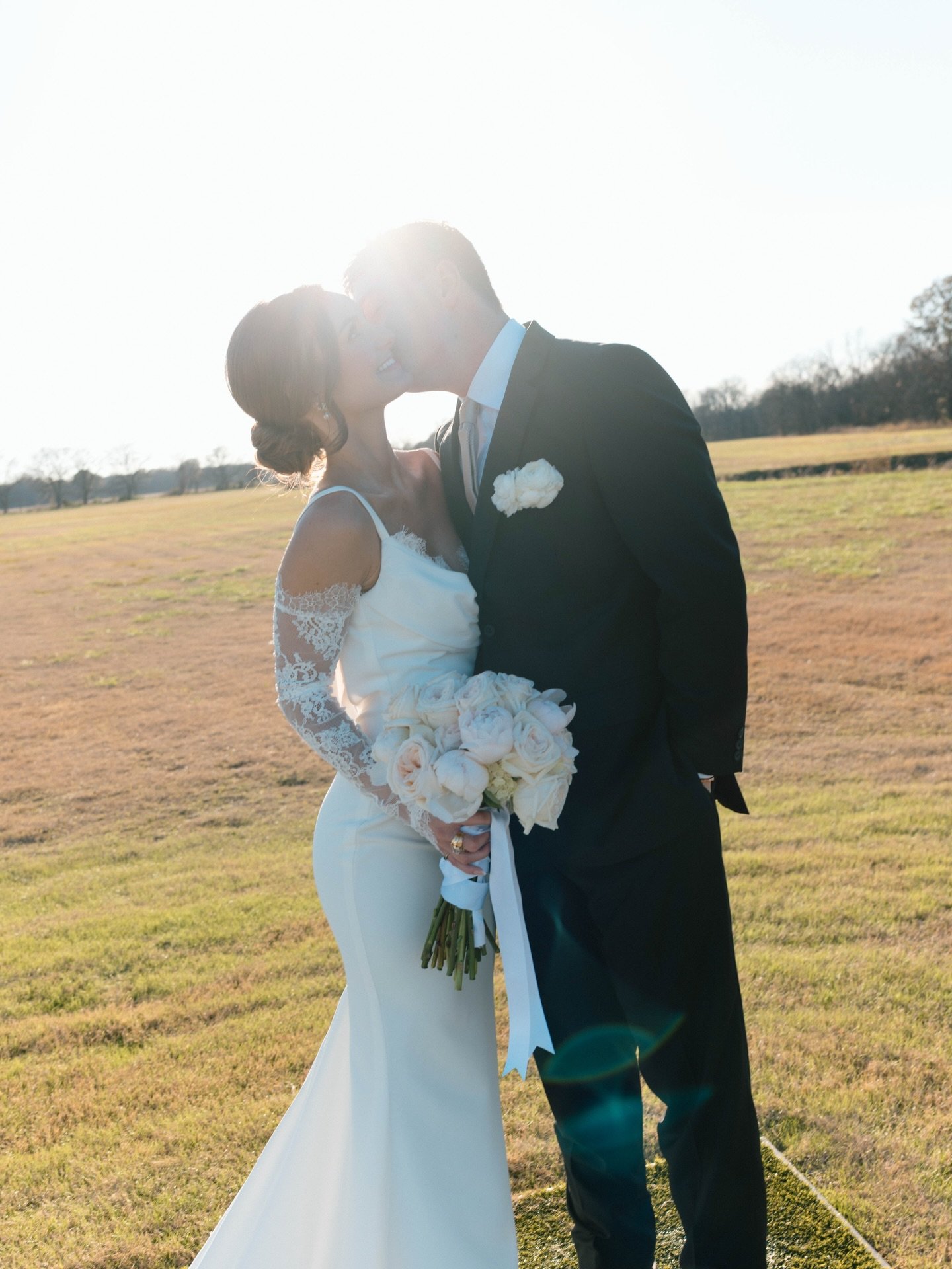 Darci &amp; Cooper 🤍 Just a few short months ago these two vowed to forever surrounded by those they love most! We are swooning over her wearing the Archie V2 gown by @mwlbride featuring a sculpted cowl back and a delicate peek of eyelash lace that 