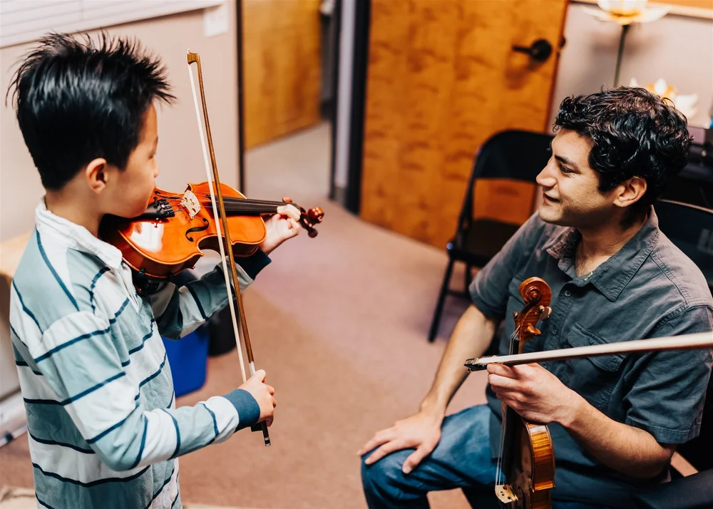 A Heart Beats violin teacher and student playing side by side