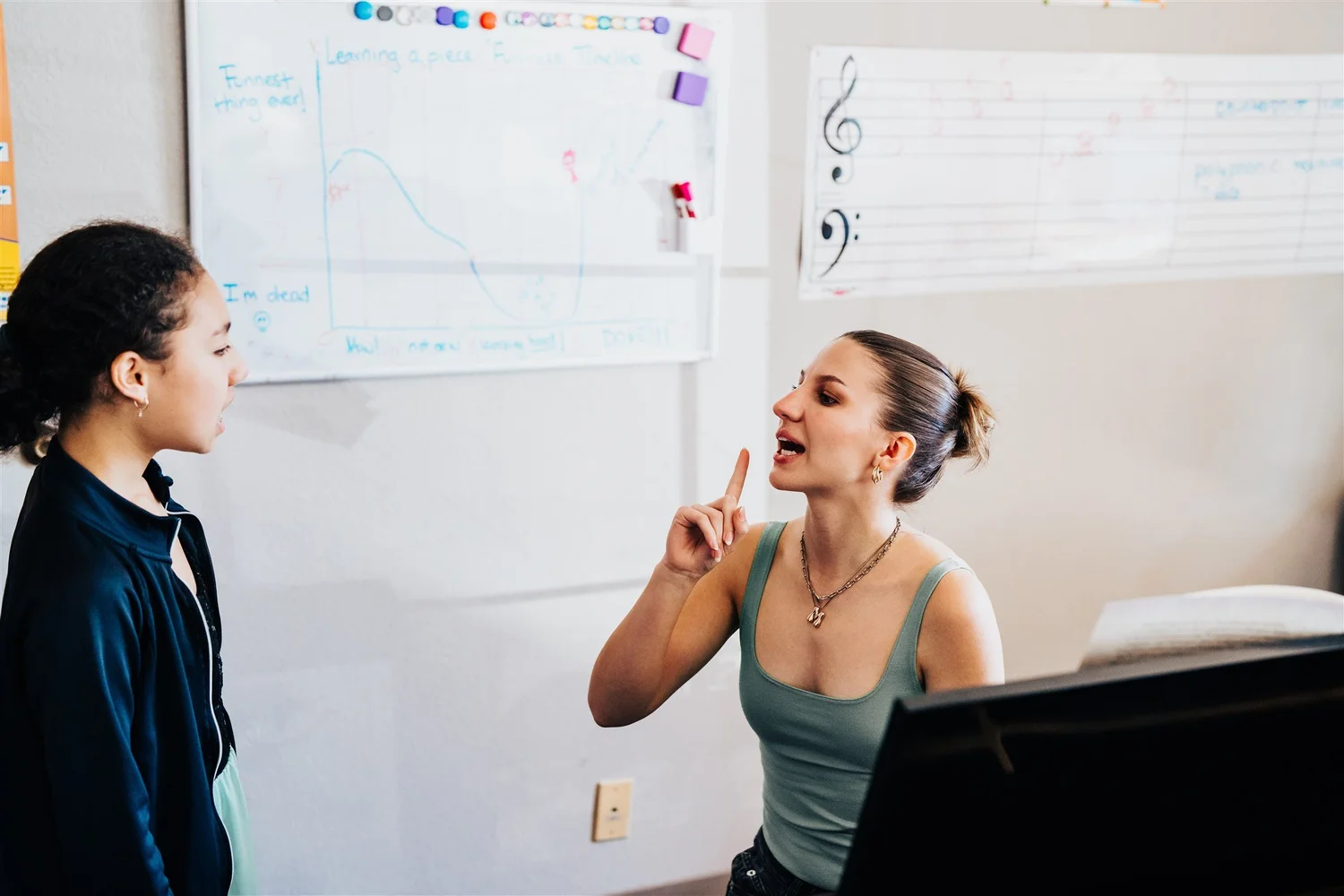 A Heart Beats voice teacher coaching a student as they sing together