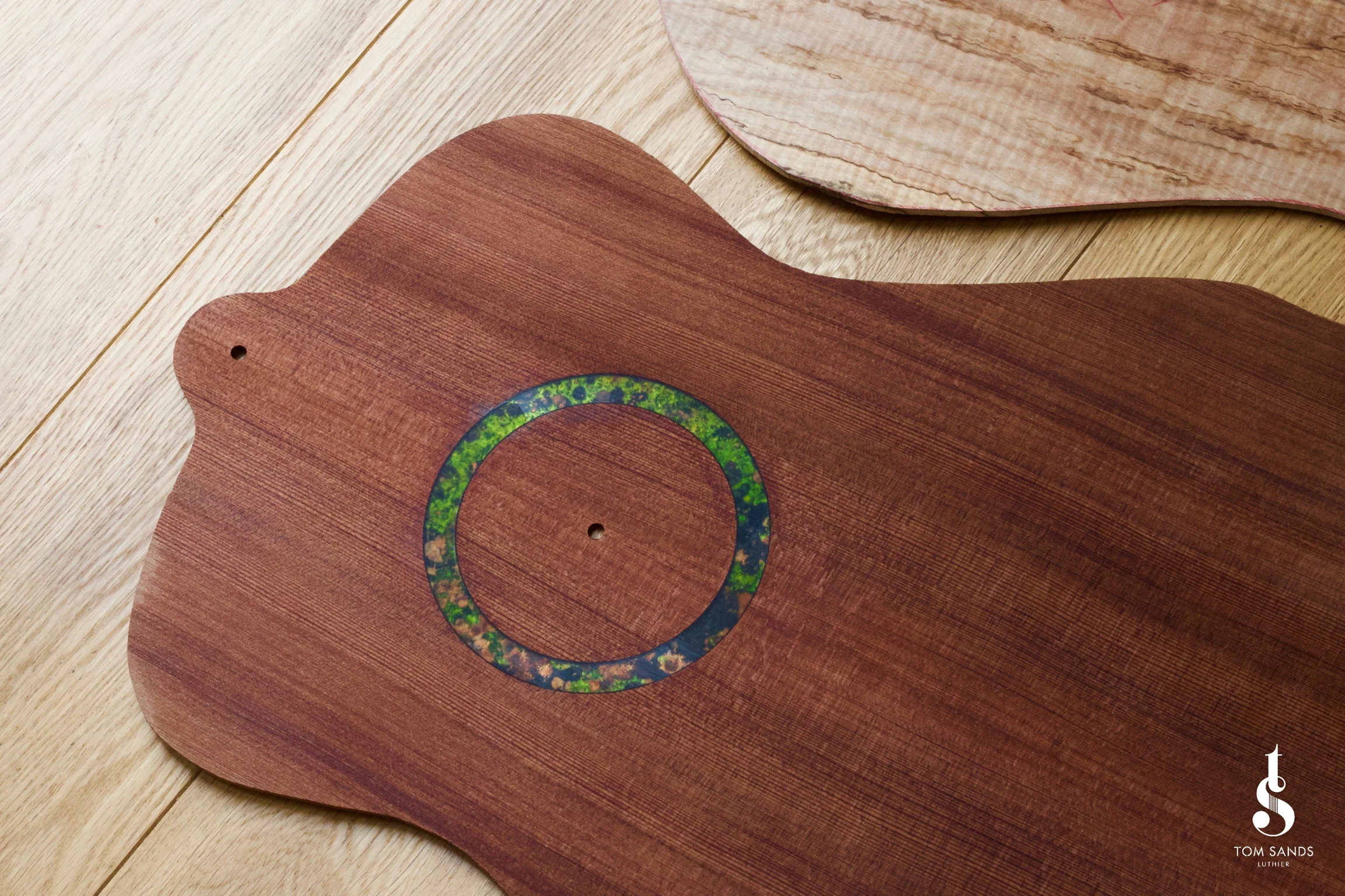 Patinated copper rosette on redwood.