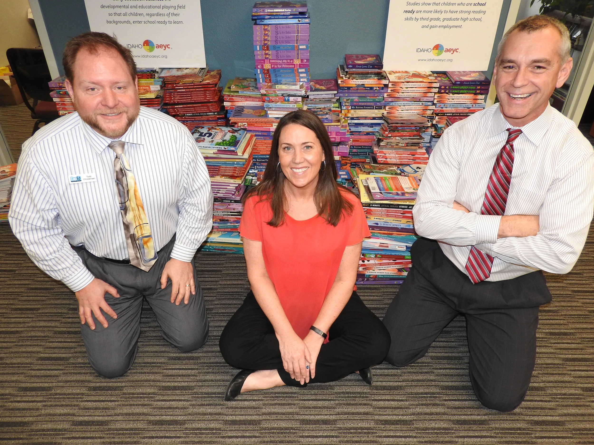  Beth Oppenheimer, Idaho AEYC, with Todd Erickson (R) and Todd Christensen (L), CapEd Credit Union in front of the 1,700+ donated books.