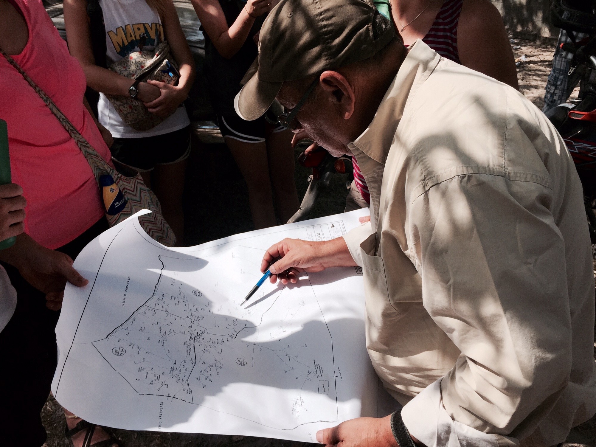 Jacobo Nunez, Director of Agua Para El Pueblo, looking at a map of the community wells. | Photo Credit: Brittany Girle from photoserve.org