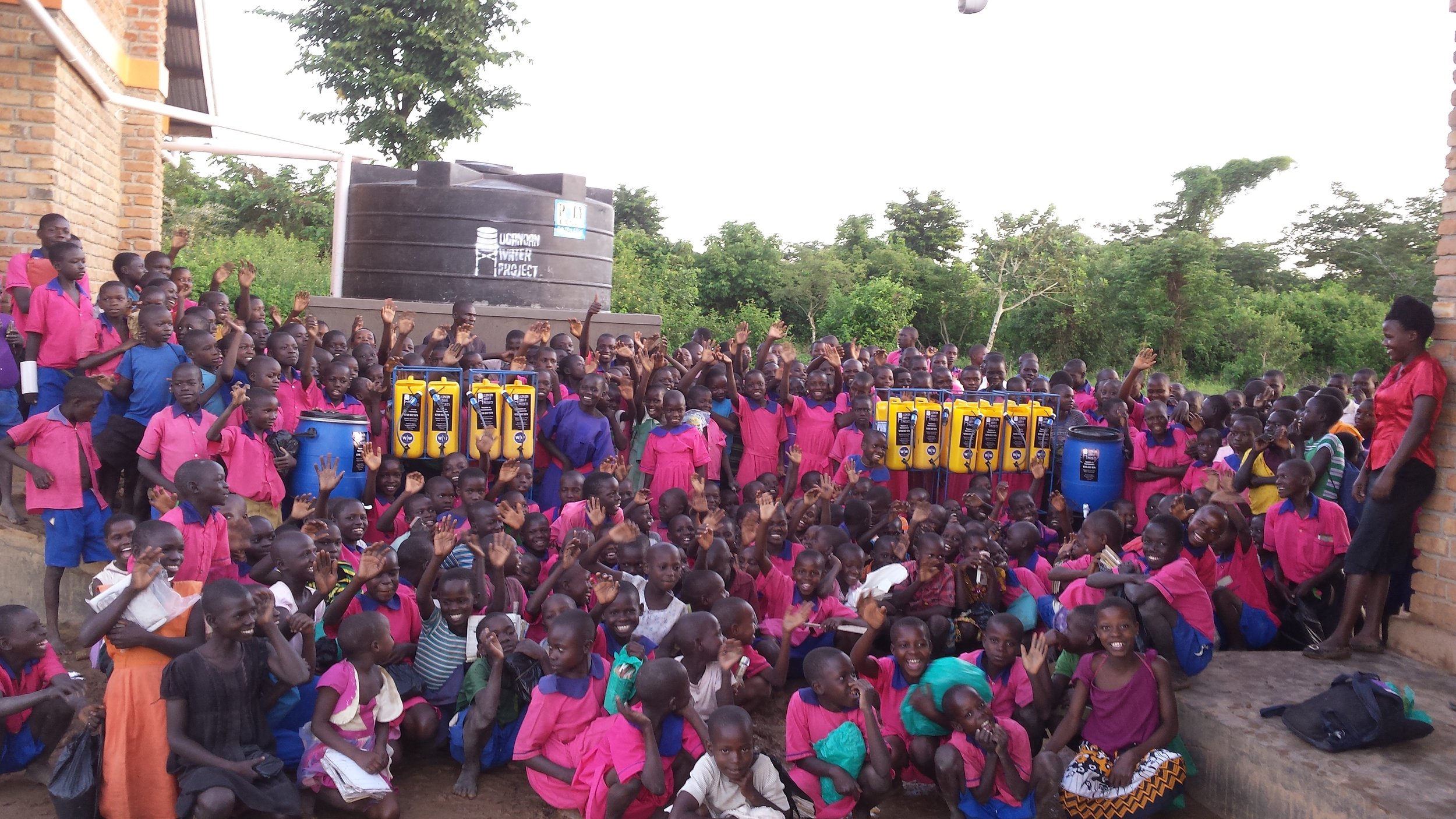 Students and Staff at Bulemezi Primary School receive new water filters. Image courtesy of Ugandan Water Project. 