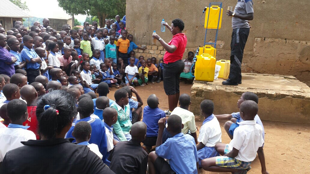St. Balikudembe students learn how to use their new Sawyer filters. Image courtesy of Ugandan Water Project