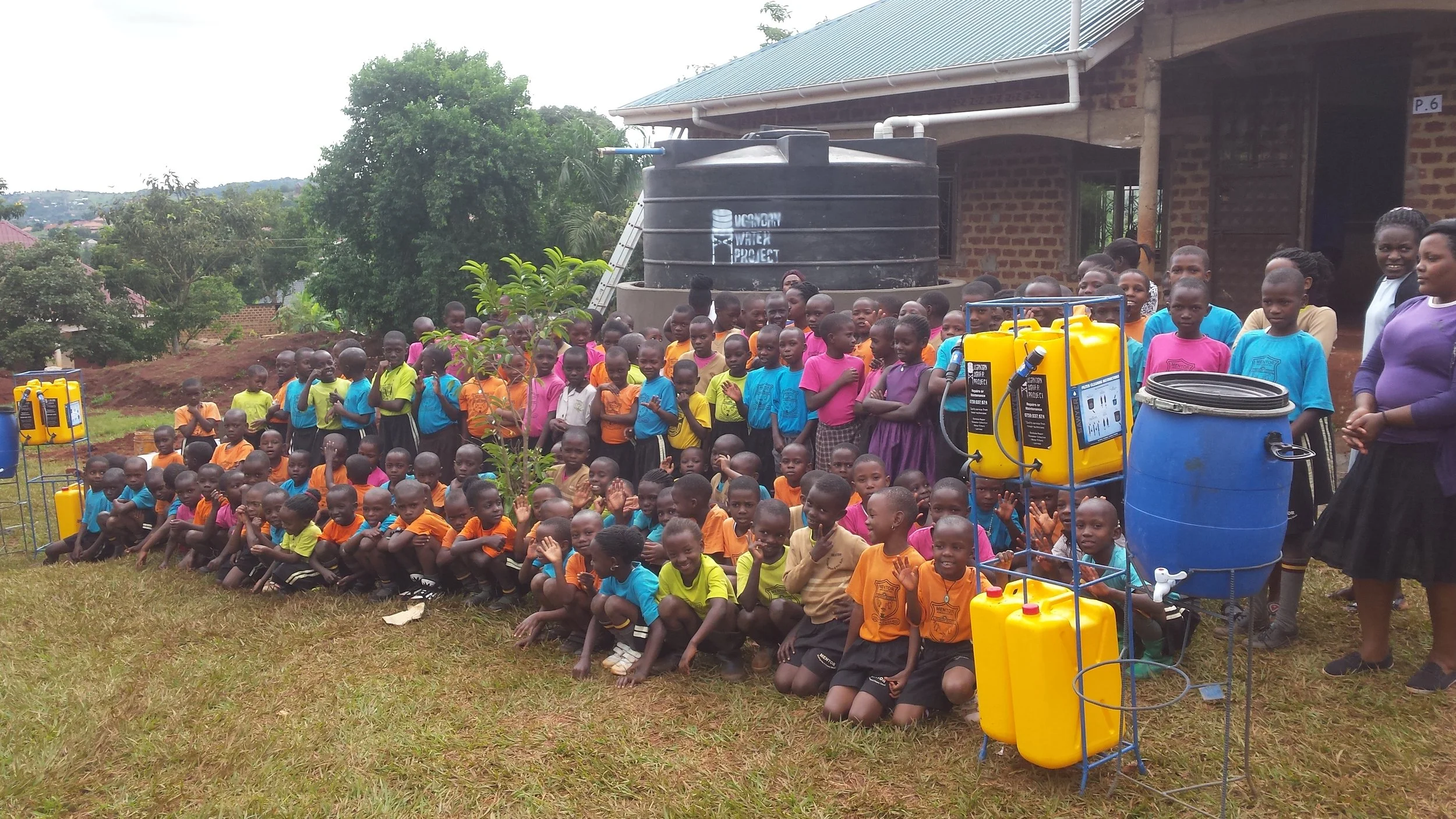 Mentor Kindergarten Students pose with their new Sawyer filters. Image courtesy of Ugandan Water Project.