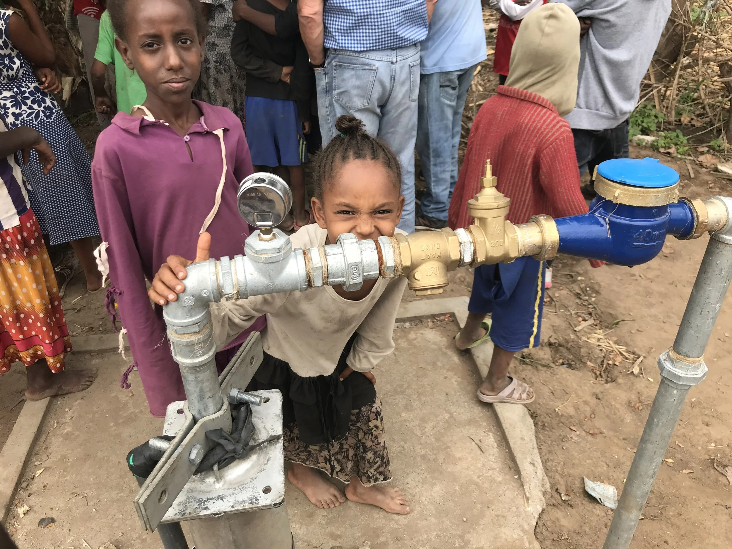 Fig. 8 Children around the new solar powered pump in Andulala. 