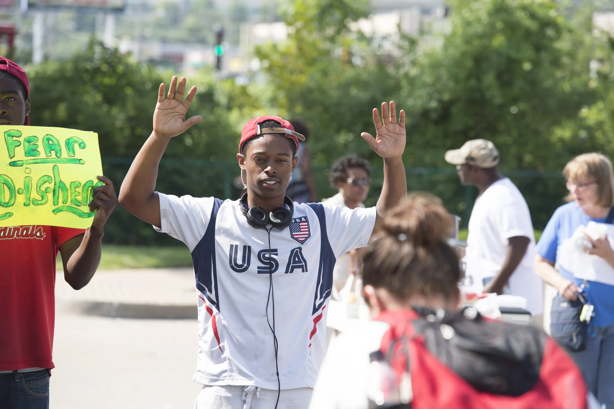 FERGUSON, MO/USA - AUGUST 15, 2014: Man holds hands up at the site of destroyed Quick Trip after Police Chief Thomas Jackson release of the name of the officer that shot Michael Brown.