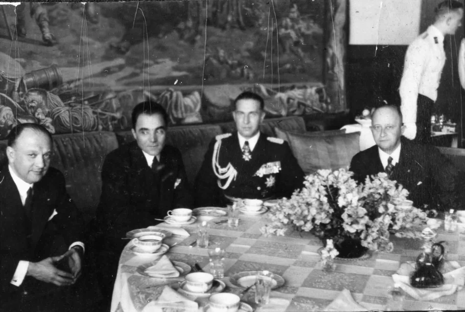 Photo taken November 21 1938, showing a delegation of the Belgian ambassador, Jacques Davignon. The photographer was Heinrich Hoffmann, who would have been standing with his back to the Berghof's giant picture window. "The Belgian legation at Berlin was elevated to an Embassy on November 21, 1938, and afterward Belgian Ambassador Vicomte Jacques Davignon attended a special reception held by Hitler at Berchtesgaden. The conversation between Hitler and Davignon turned to the Czech question. Hitler explained that German relations with Czecho-Slovakia were far from settled and he enumerated the difficulties which were unresolved. Davignon was impressed with the frankness of Hitler's remarks." The Forced War, When Peaceful Revision Failed, David L. Hoggan, 1961
