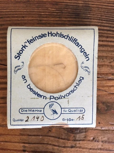 A packet of H Stork fishing hooks. Notice the stork logo at the bottom. 