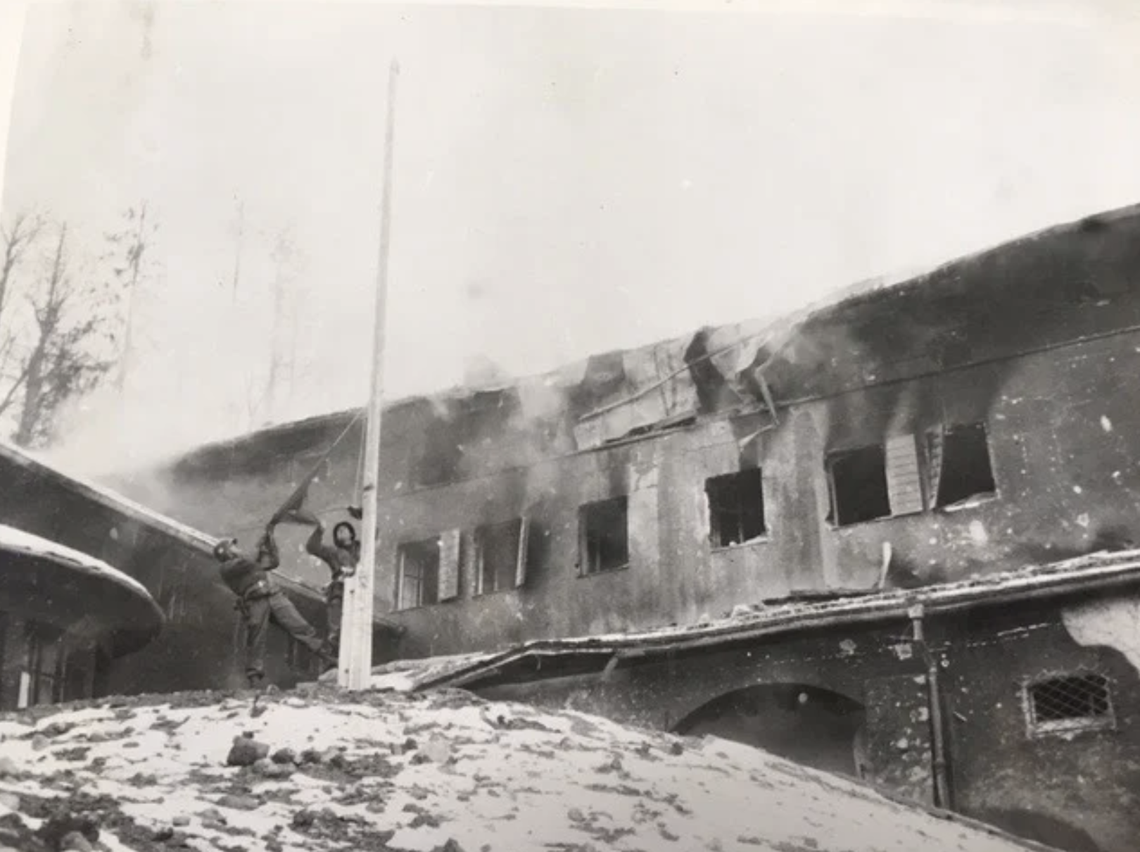 Soldiers from the 7th Infantry Regiment, 3rd Infantry Division, tear down Hitler’s Berghof flag on May 4 1945. Later, this ultimate souvenir would be cut up and divided among the men.