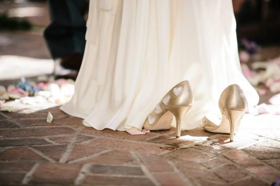 snapshot: our wedding photographer caught me slipping off my shoes mid-ceremony.
