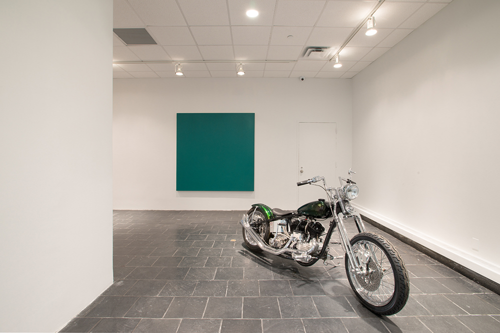  Installation view:  Olivier Mosset , Hunter College Art Galleries, 2016. Photo by Bill Orcutt. Left to right:  U2 , 2015. Acrylic on canvas, 72 x 72 in. Galerie Andrea Caratsch, Zurich / St. Moritz.  Flathead 1954 . 1954 Harley Davidson, 45 cubic in