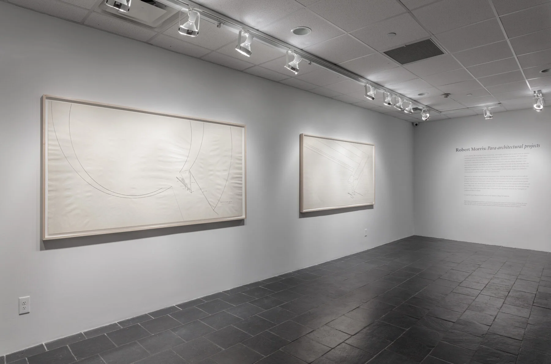Installation view: Robert Morris: Para-architectural projects , Hunter College Art Galleries, 2019. LEFT: Section of an Enclosed Courtyard , 1971. Ink on paper, 42 x 82 ½ in. (107 x 210 cm). Estate of Robert Morris, courtesy Castelli Gallery, New York. RIGHT: Section of a Walled Courtyard , 1971. Ink on paper, 42 x 84 in. (107 x 213 cm).Courtesy of Hunter College, The City University of New York. © 2019 The Estate of Robert Morris / Artists Rights Society (ARS). Photo: Stan Narten