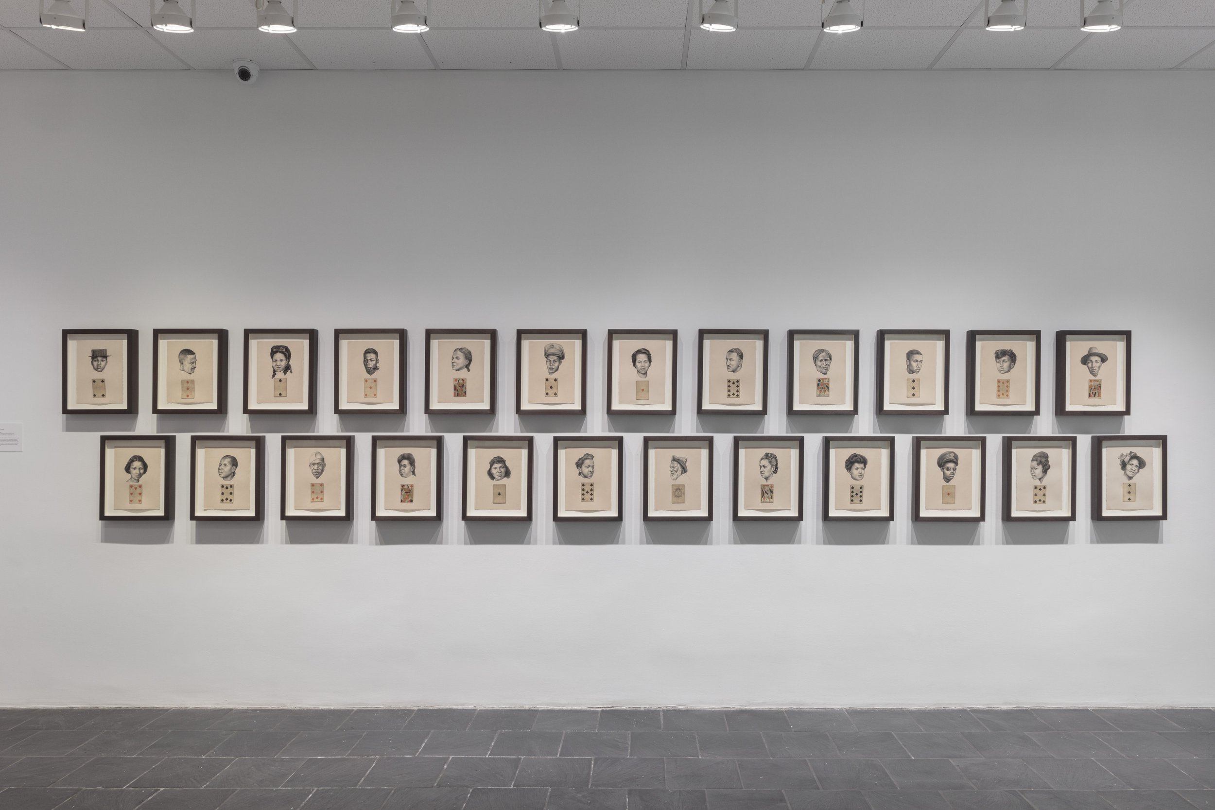  Installation view of  The Black Index  at Hunter College Art Galleries’ Leubsdorf Gallery, 2022. Photo: Stan Narten. Whitfield Lovell.  The Card Pieces , 2020. Series of charcoal pencil on paper with attached playing card, 12 x 9 inches each. Courte