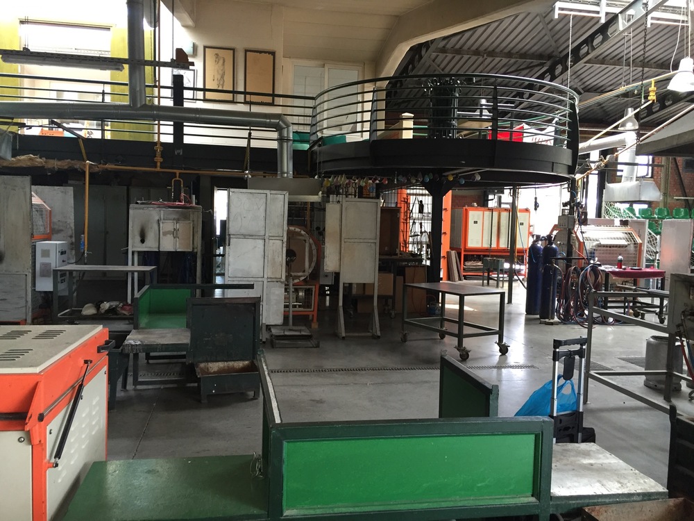  Here's a view of the studio - this is the bench we worked on most. To the left is another bench with a larger glory hole, to the right is the area where the production team worked. You can kind of see the green chairs in the top right - school group