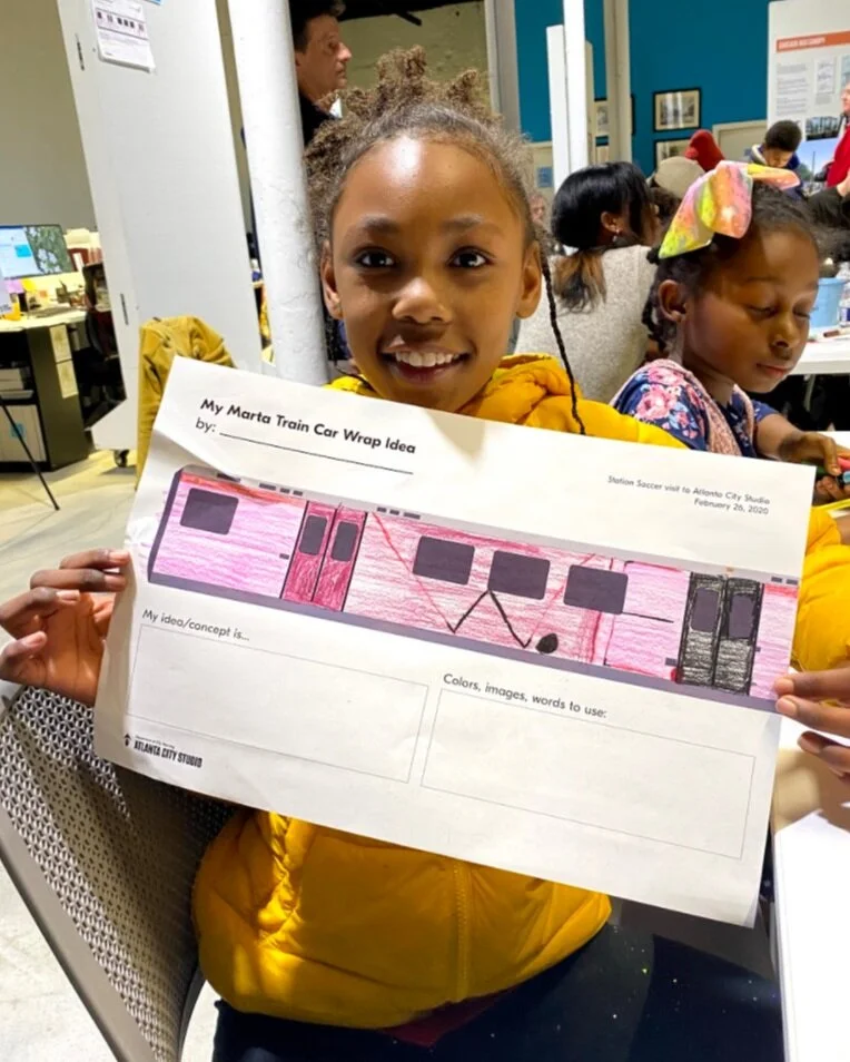 Taniyah showing her creative design on the railcar wrap