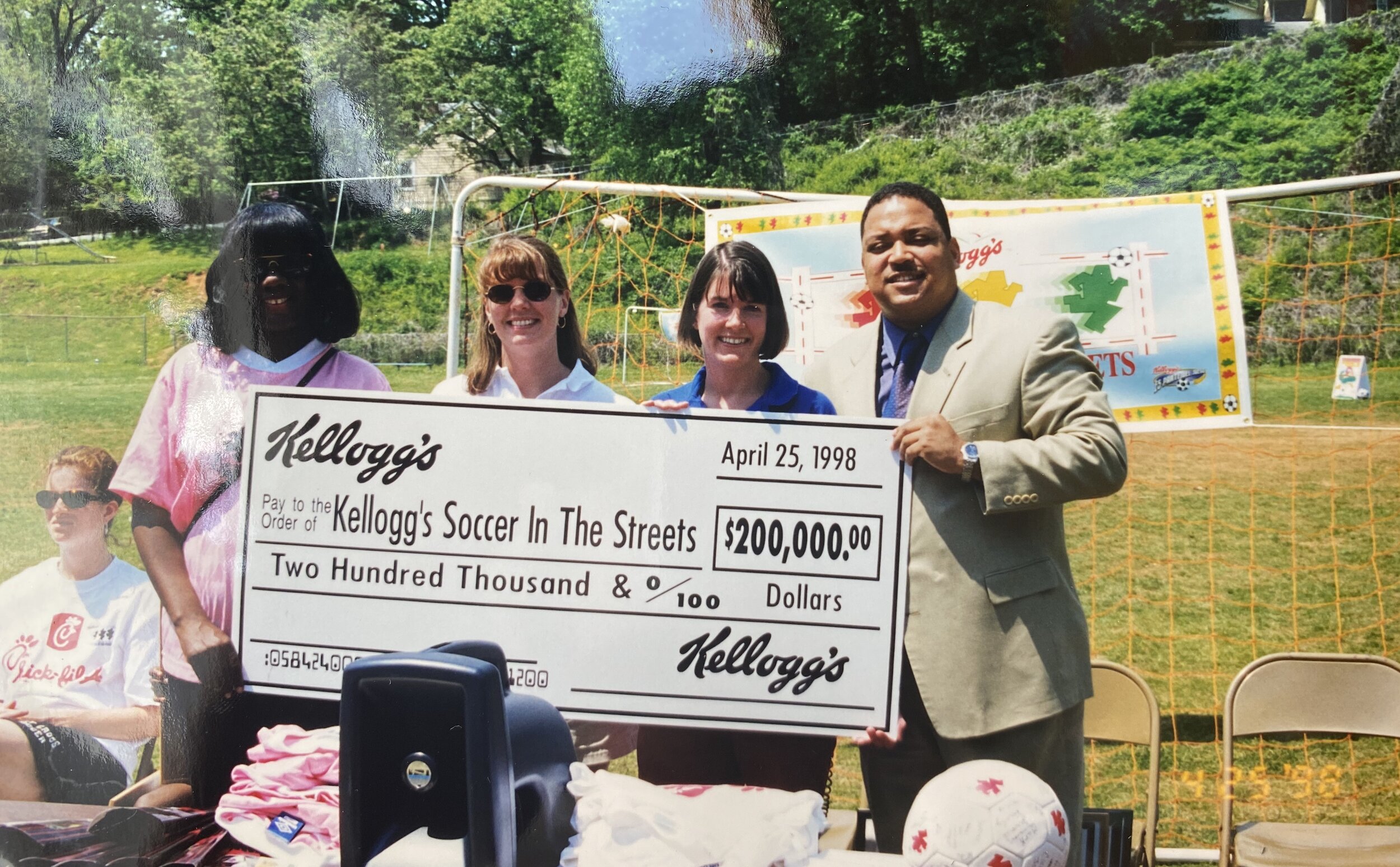  Carolyn McKenzie at Kellogg’s Super Show with check presentation 