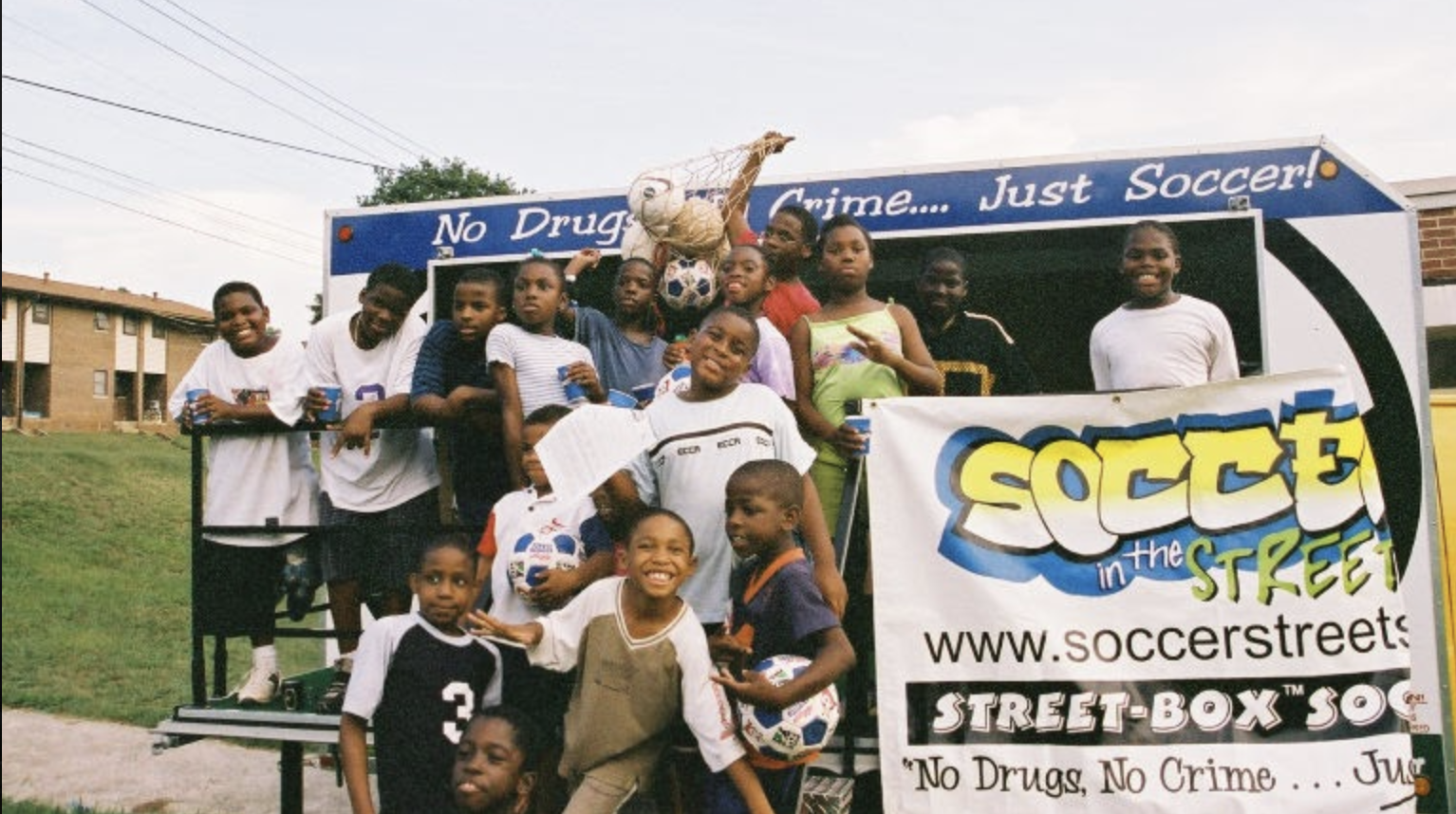  Soccer in the Streets youth players at tournament with the SITS bus 