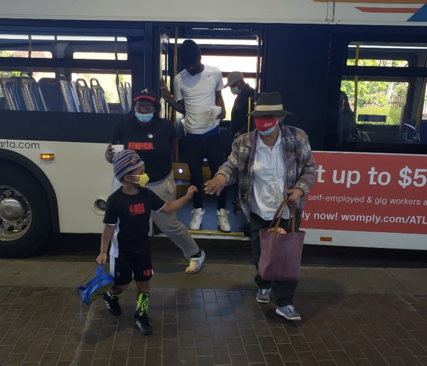 West End grandmother Cheryl and grandson Carter exiting the MARTA bus for youth practice