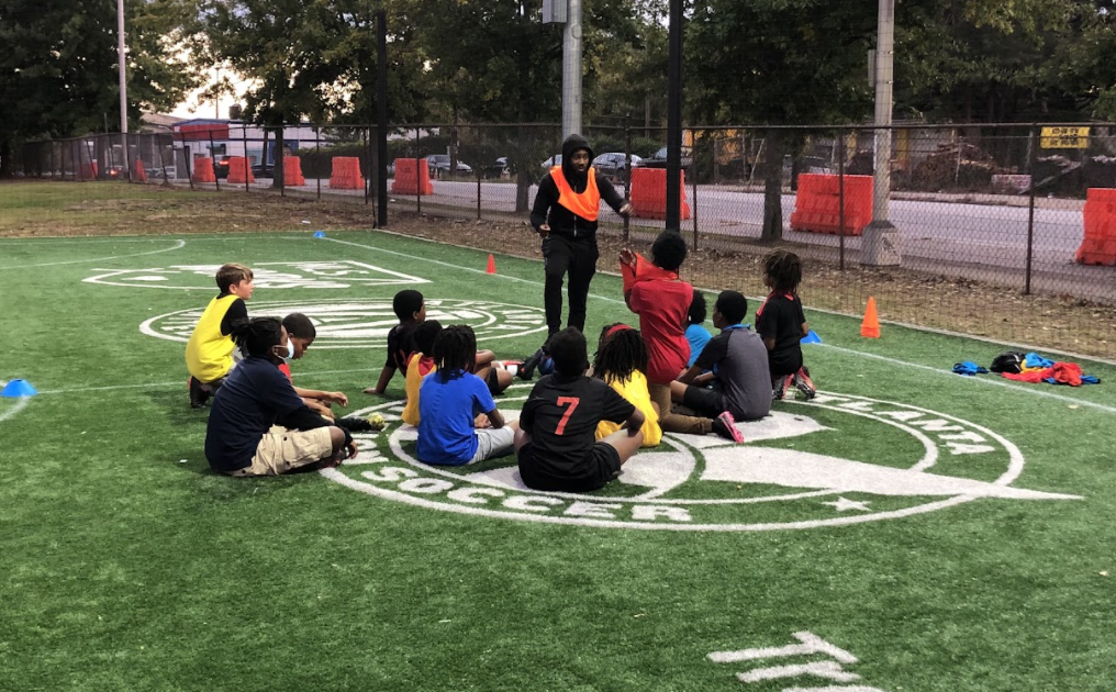  Coach Rajay going over drills for practice 