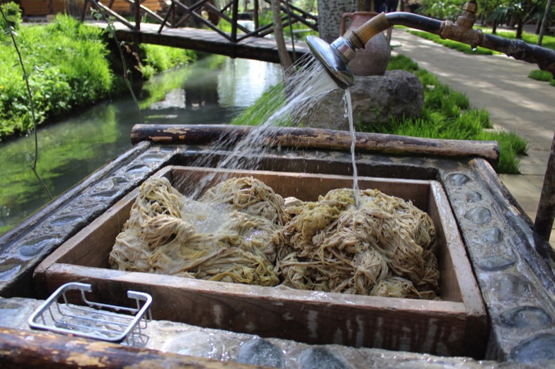   The mulberry bark is boiled for five hours and softens, then pounded and washed to remove excess dirt and fibers Photo credit: Willis Hughes  