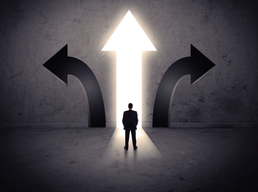 Businessman in front of three arrows