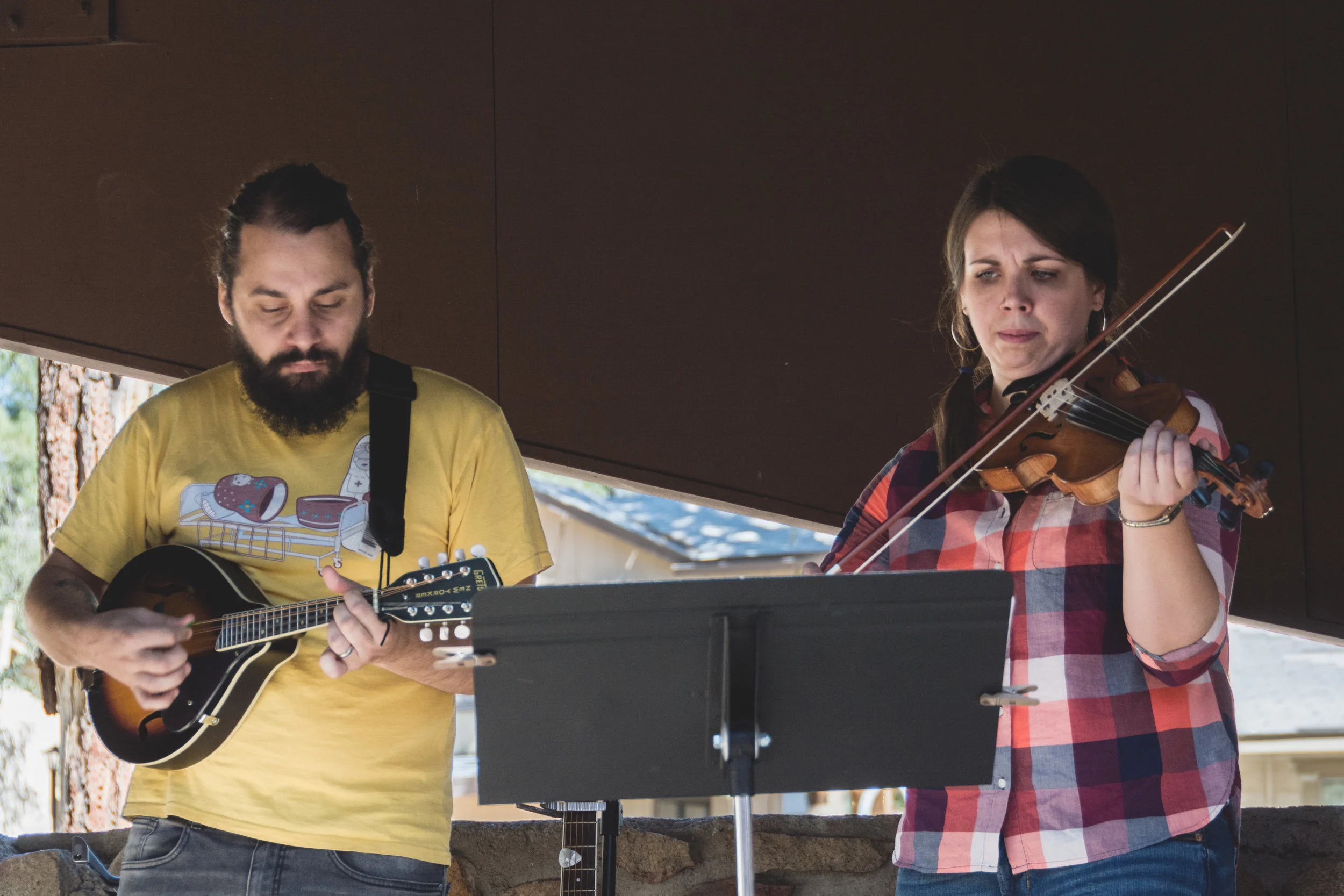 Josh pretends he knows how to mandolin alongside TMC's new teaching pastor, Meghan Good, at the fall church retreat.