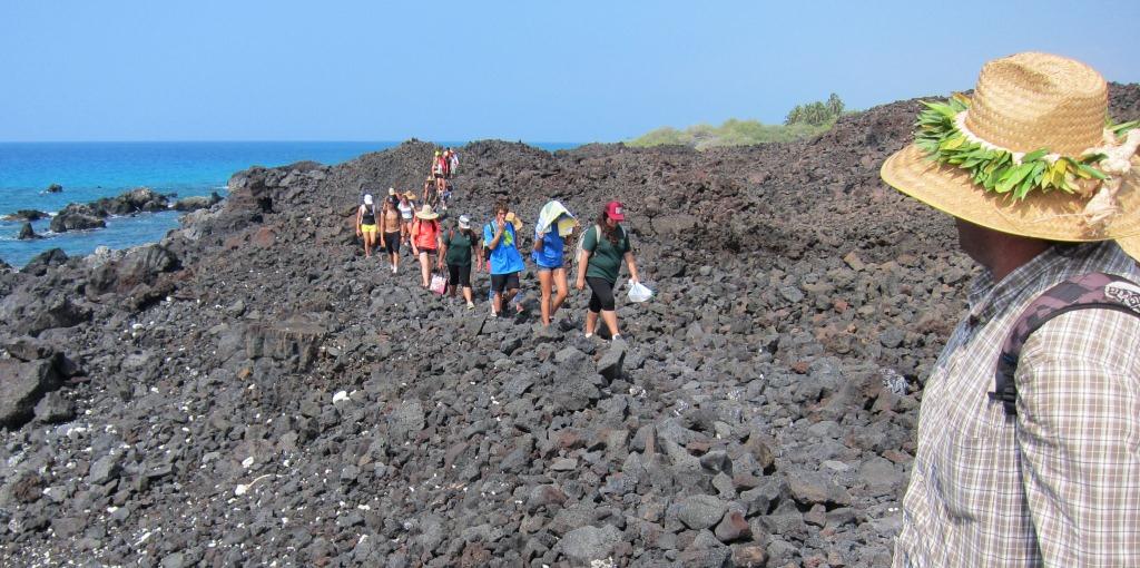     Youth and their sponsors walking on the lava rock coastal trail. Photo by Nancy Erger.    