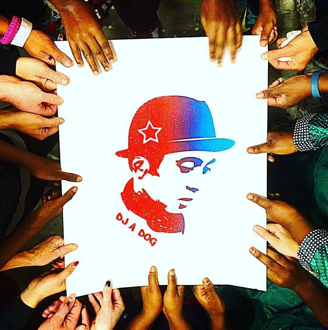 Community members holding artwork honoring Andy A_Dog Williams