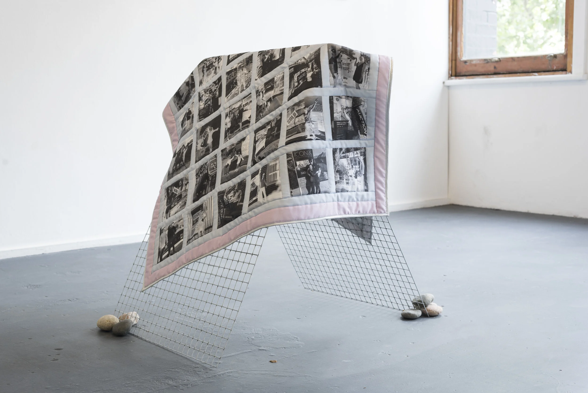 Aaron Claringbold Absolve my quilt First home buyers baby quilt; found images printed on cotton, South Australian wool, Chinese steel support, assorted Chinese Tuscan River Rocks 101 x 113 cm, dimensions variable 2018 Photo by Aaron Claringbold