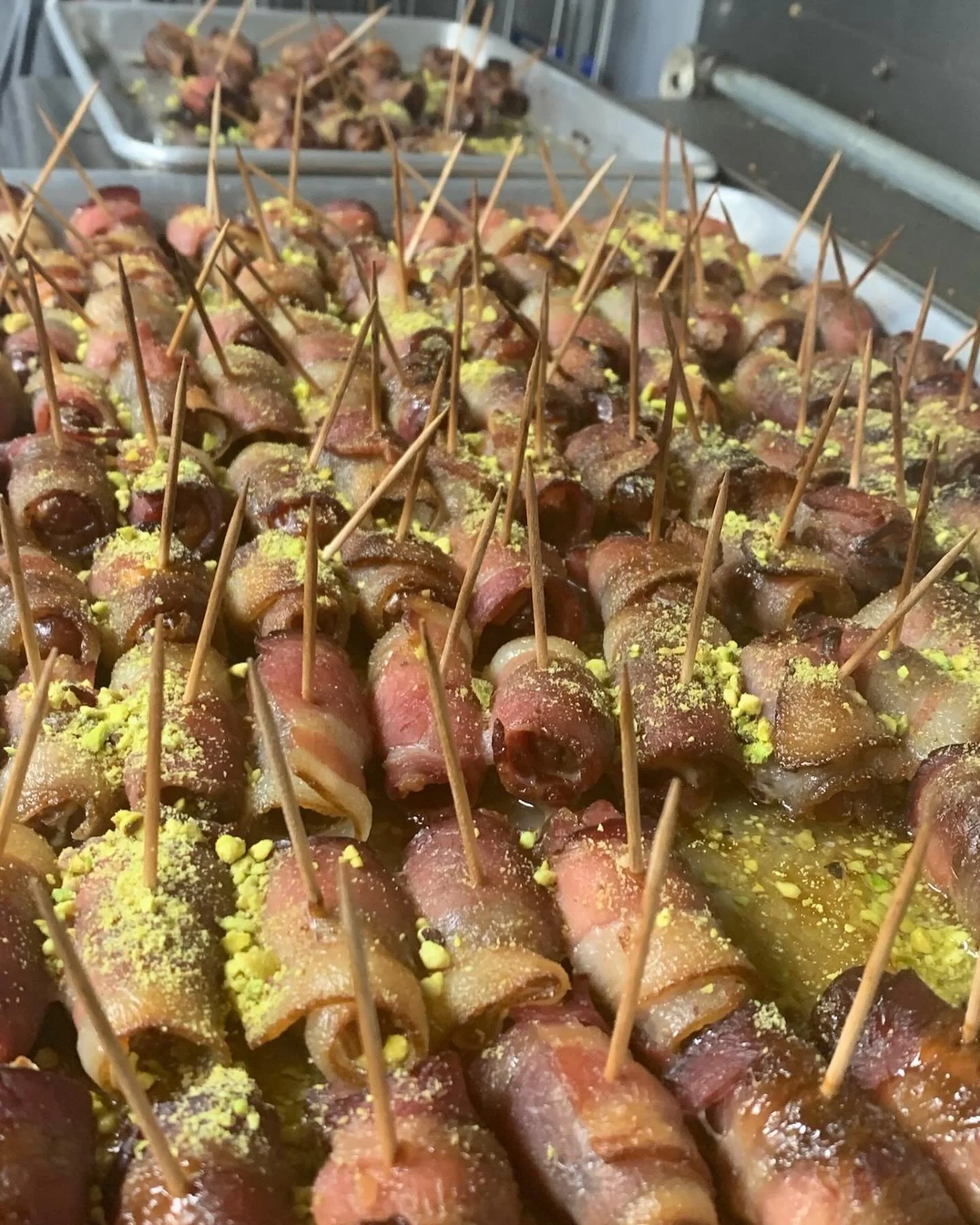 Bacon wrapped dates stuffed with goat cheese and topped with crushed pistachio. One of our most popular appetizers at weddings.