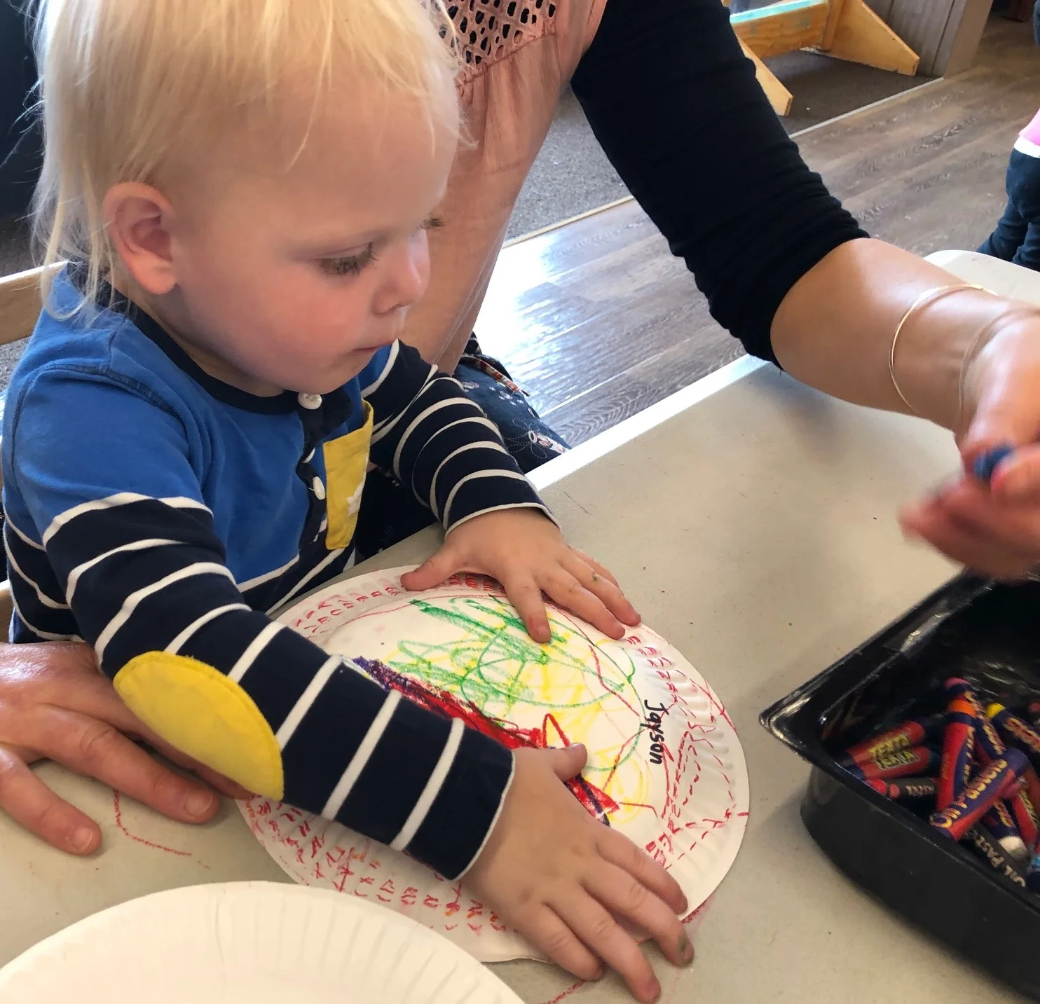 Oil pastels are great for adding vibrant colours. It is easier to decorate the plate flat, before folding.