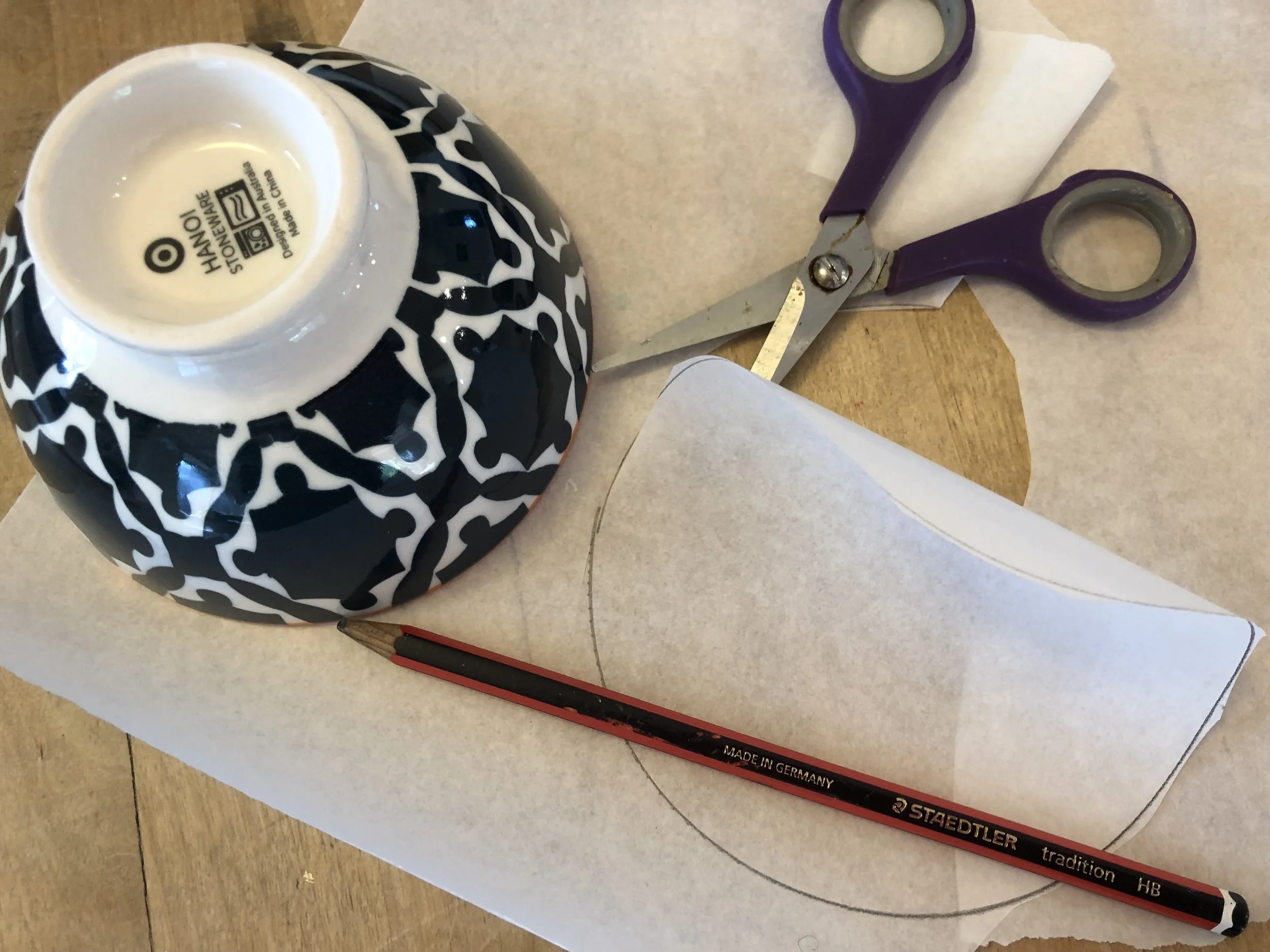 Use a bowl to trace a circle of kitchen paper, and cut it out.