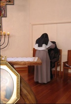 Sister Agatha blessing the Archbishop with the veil of St Colette