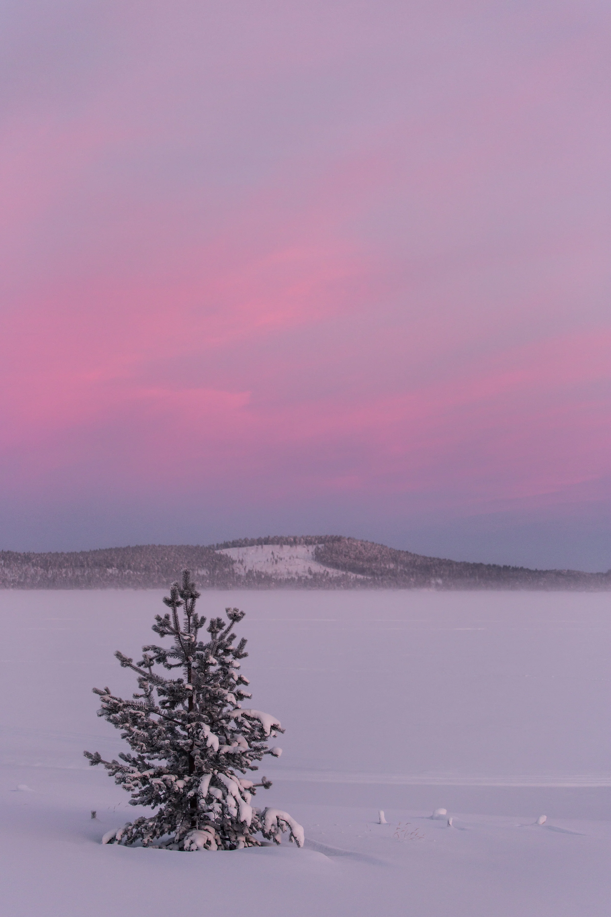 The landscape blanketed with snow, whilst the high cloud accentuates the Polar colour palette.