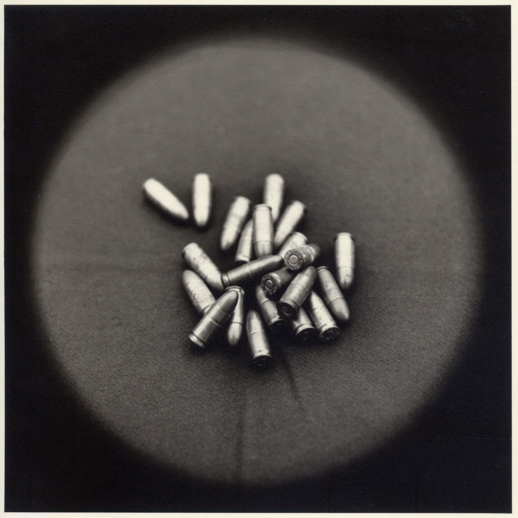   Bullets, confiscated ammunition   Toned gelatin silver print.   16 x 16 in. (40 x 40 cm.) 