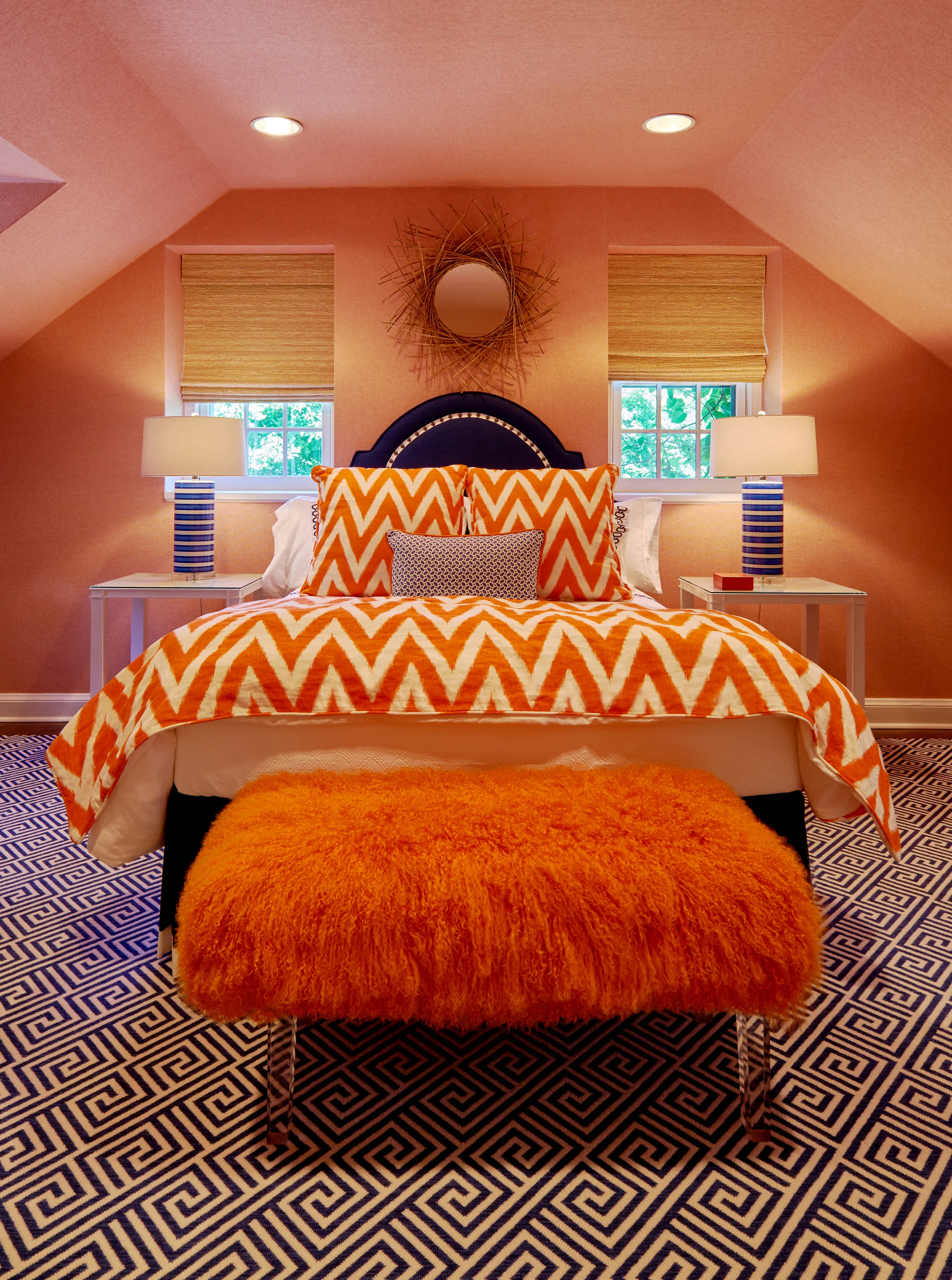 Furry bench on lucite adds texture to this inviting guest room.