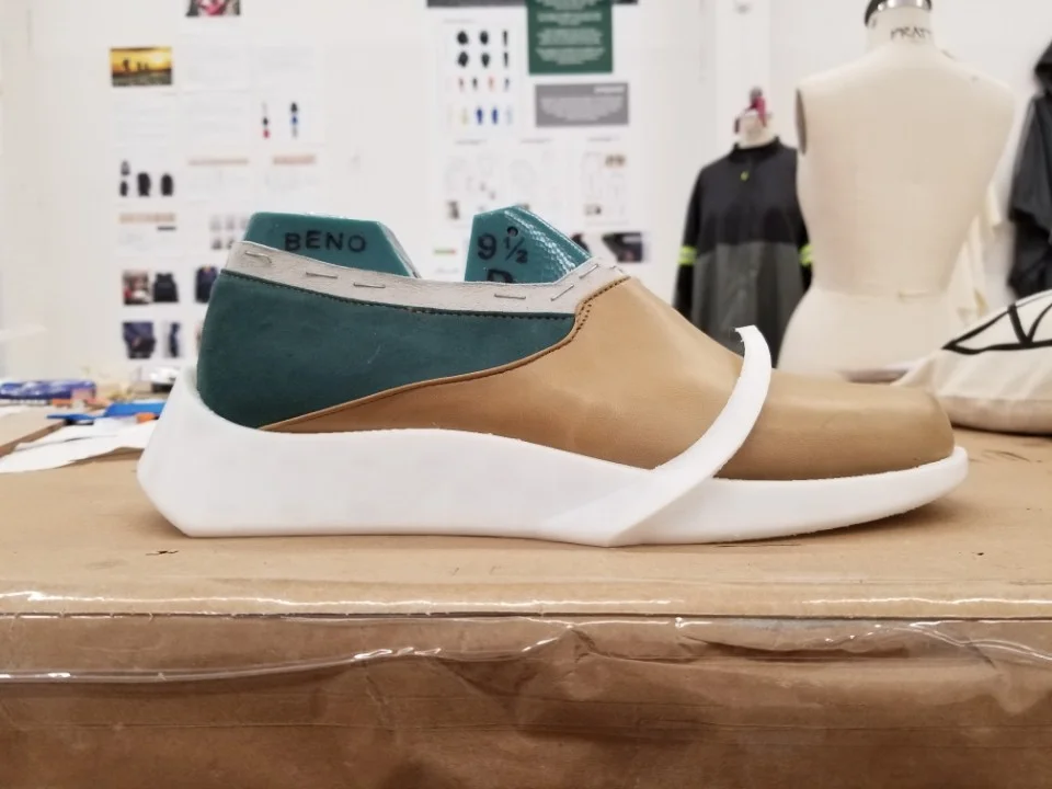 The out sole was redesigned, and printed. The last is placed onto the out sole to check fit and size. 