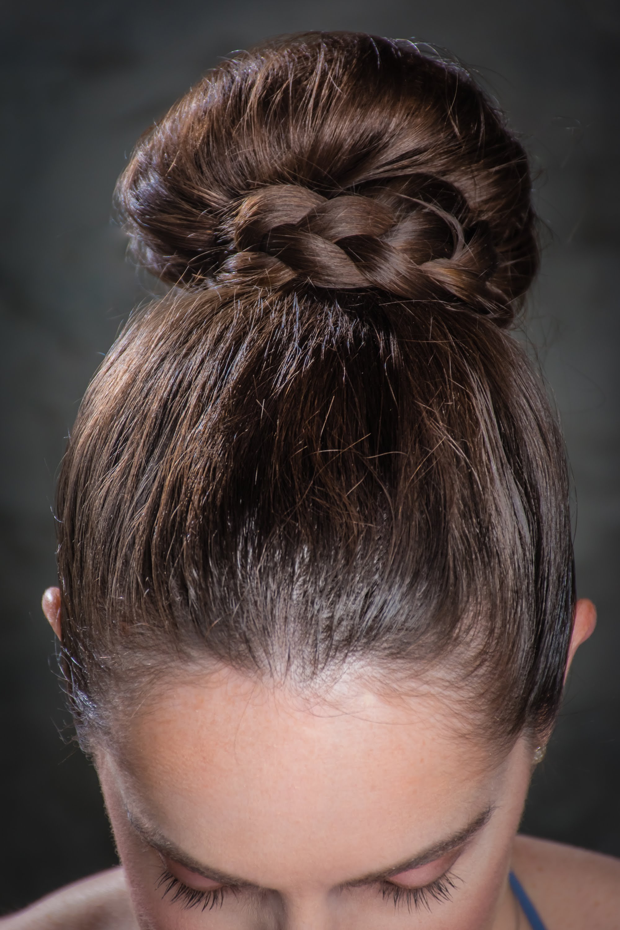  The bridesmaid had thick shoulder length hair. I created a sock-bun and then wrapped a braid from her own hair around the bun to create a classic wedding and bridesmaid hairstyle 