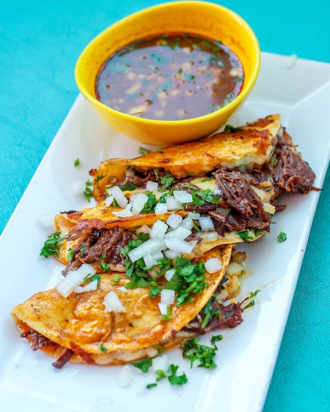 Happy Taco Tuesday!! Welcome your belly to the most delicious taco ever! The Quesabirria has adobo braised beef cheek, Monterrey and chihuahua cheese, with cilantro and onion DUNKED in birria broth $12 😛🌮 Available all week!