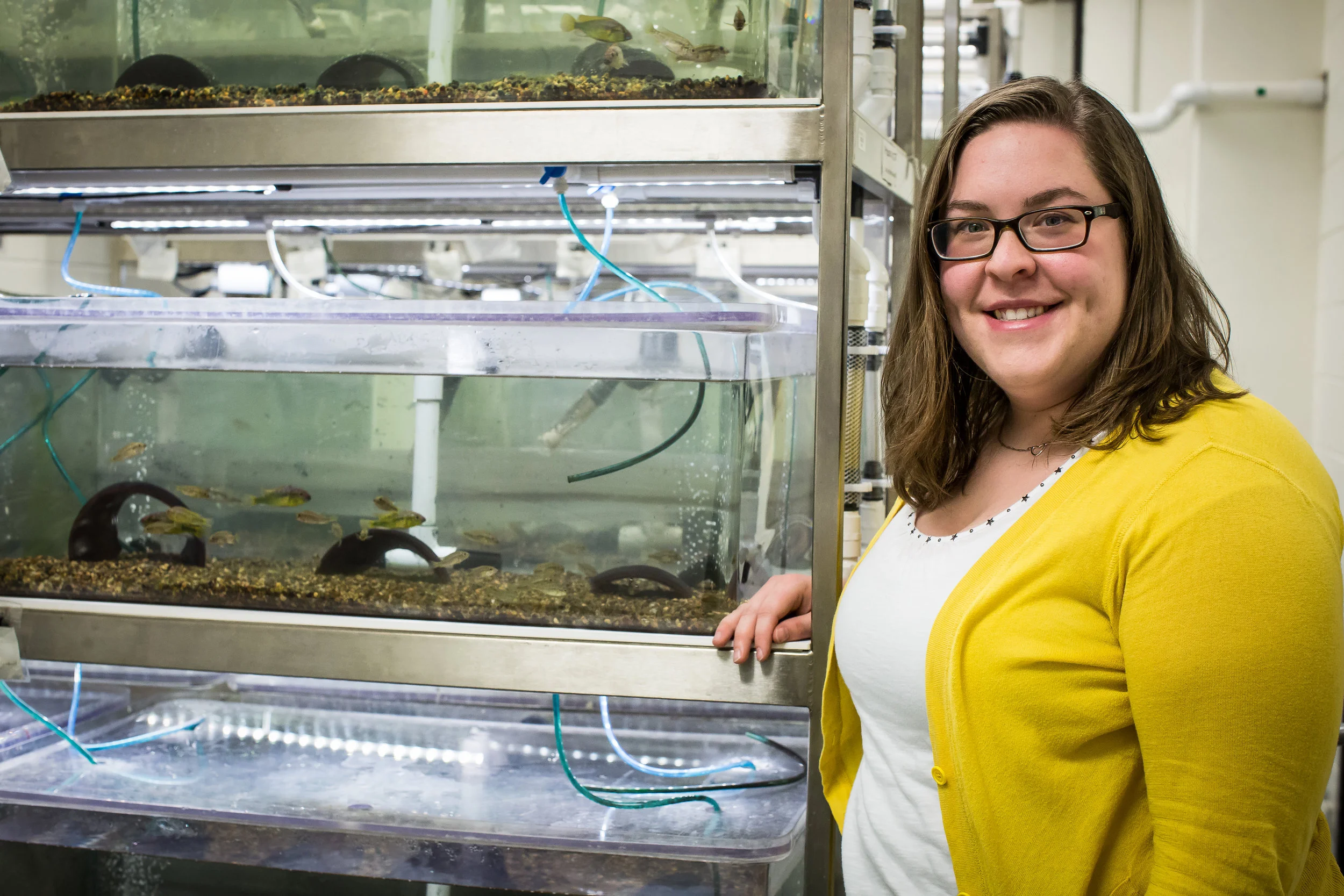 Julie Butler stands in front of tanks where "Burt" fish live LSU. Photo by Paige Jarreau.