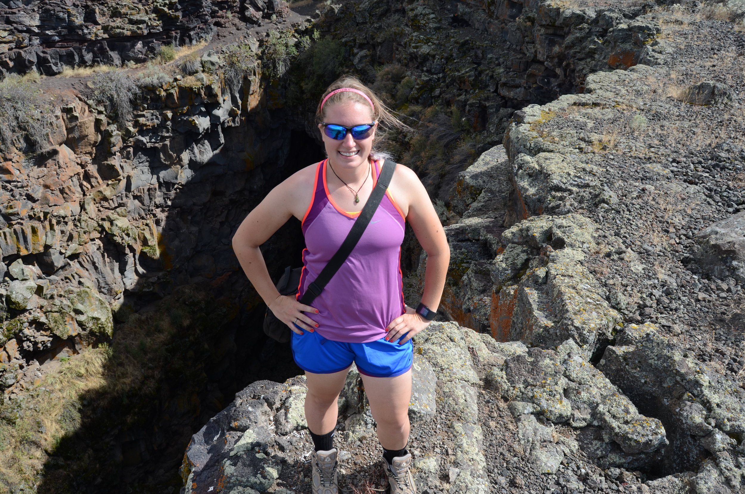 Nicki Button conducting fieldwork at Kings Bowl, an explosive volcanic vent that once ejected many large blocks in Craters of the Moon National Monument and Preserve. Button looked at the block distribution around the vent as an analog site to volcanic vents on early Mars. Photo compliments of Nicki Button.