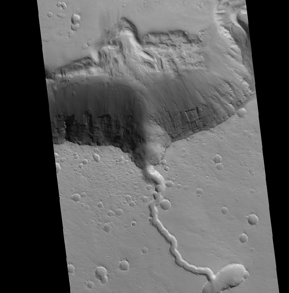 A solidified lava flow over the side of a crater rim of Elysium. Credit: NASA HiRISE image, compliments of David Susko.