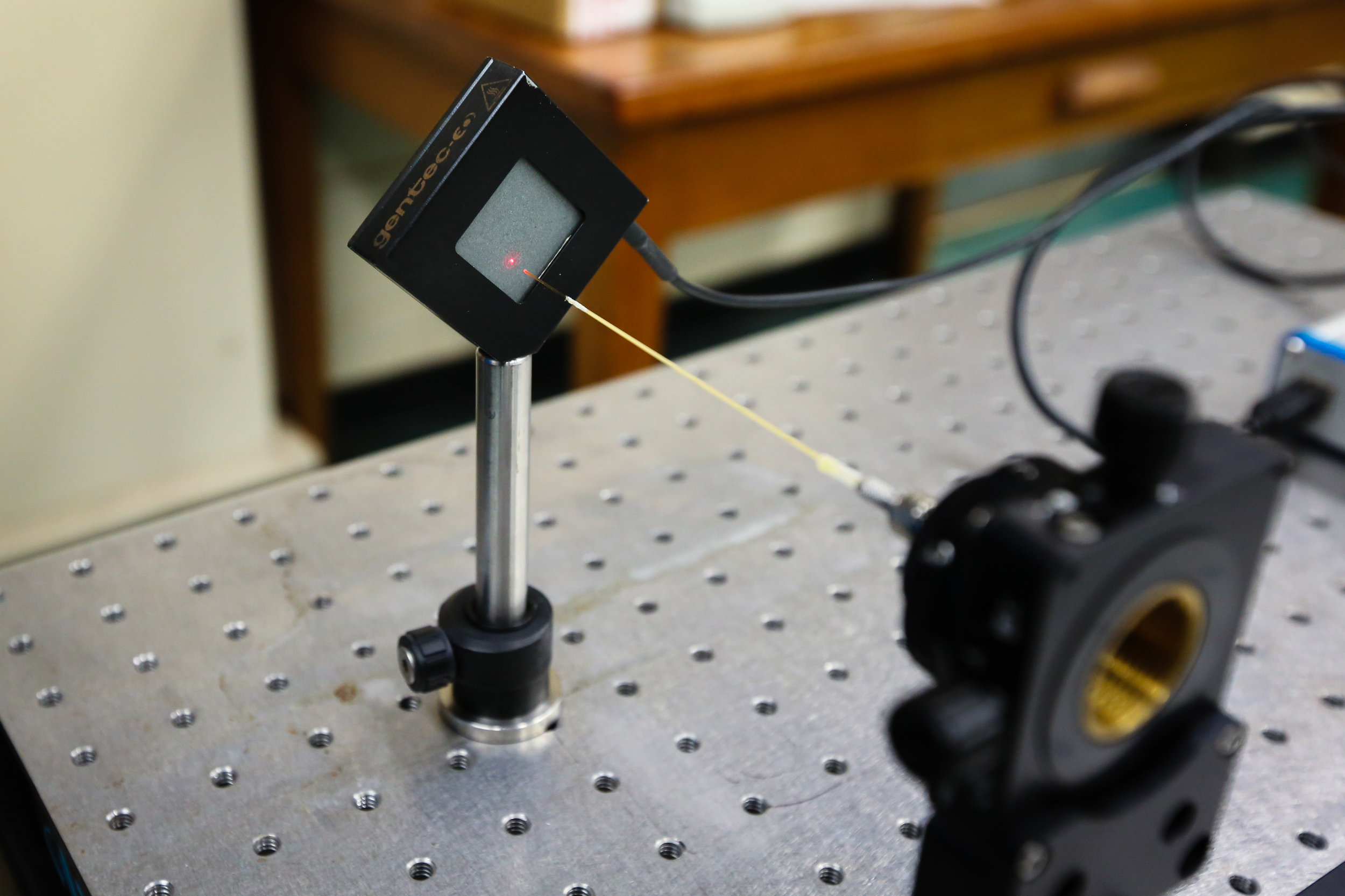 Image: The infrared laser in Murray's lab used to ablate fingermarks. Here, the laser is being channeled through an optical fiber. Credit: Paige Jarreau.