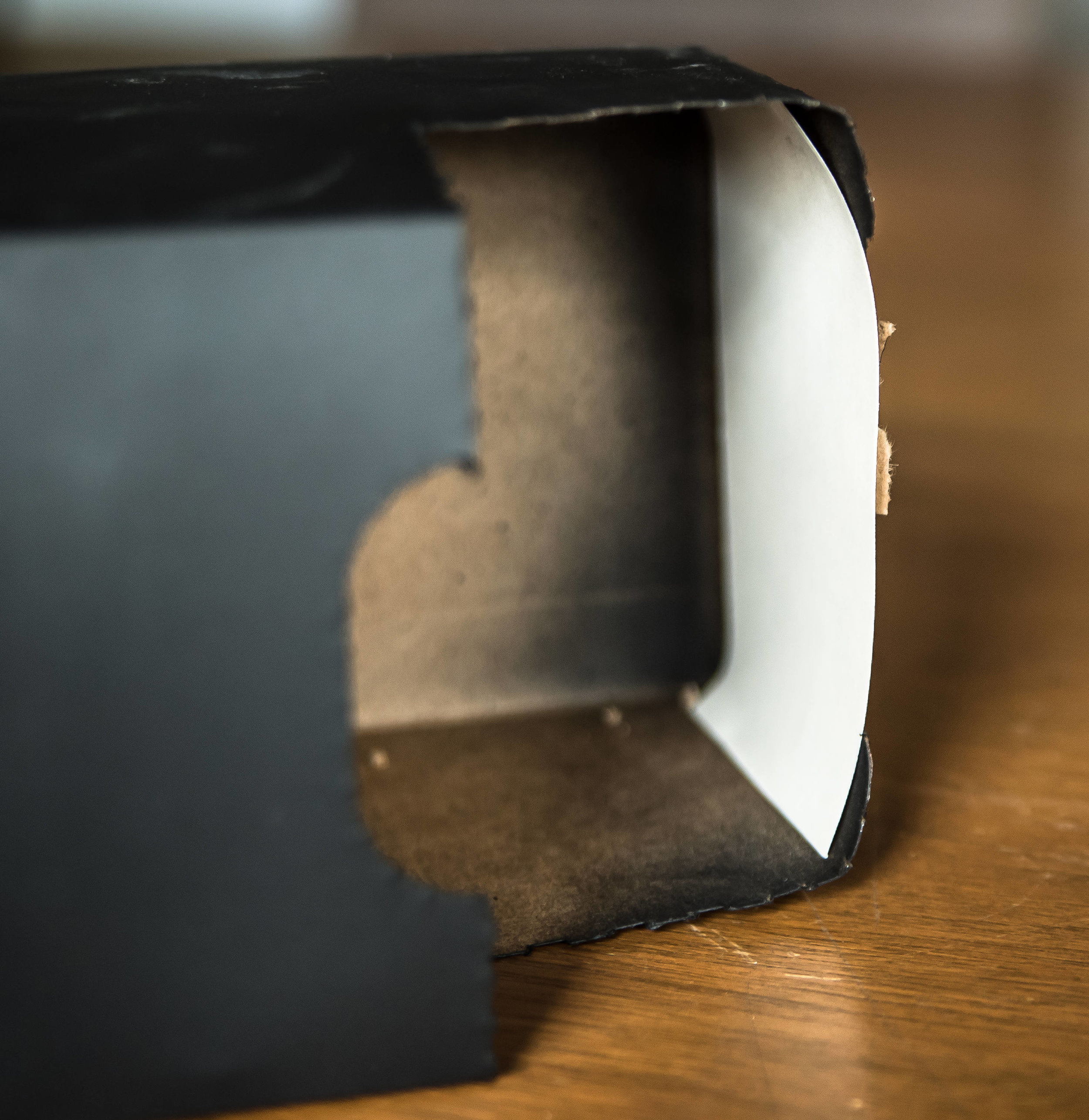 In the space where the soda box tears open, cut a piece of white paper to fit along the bottom. The sun will appear here!