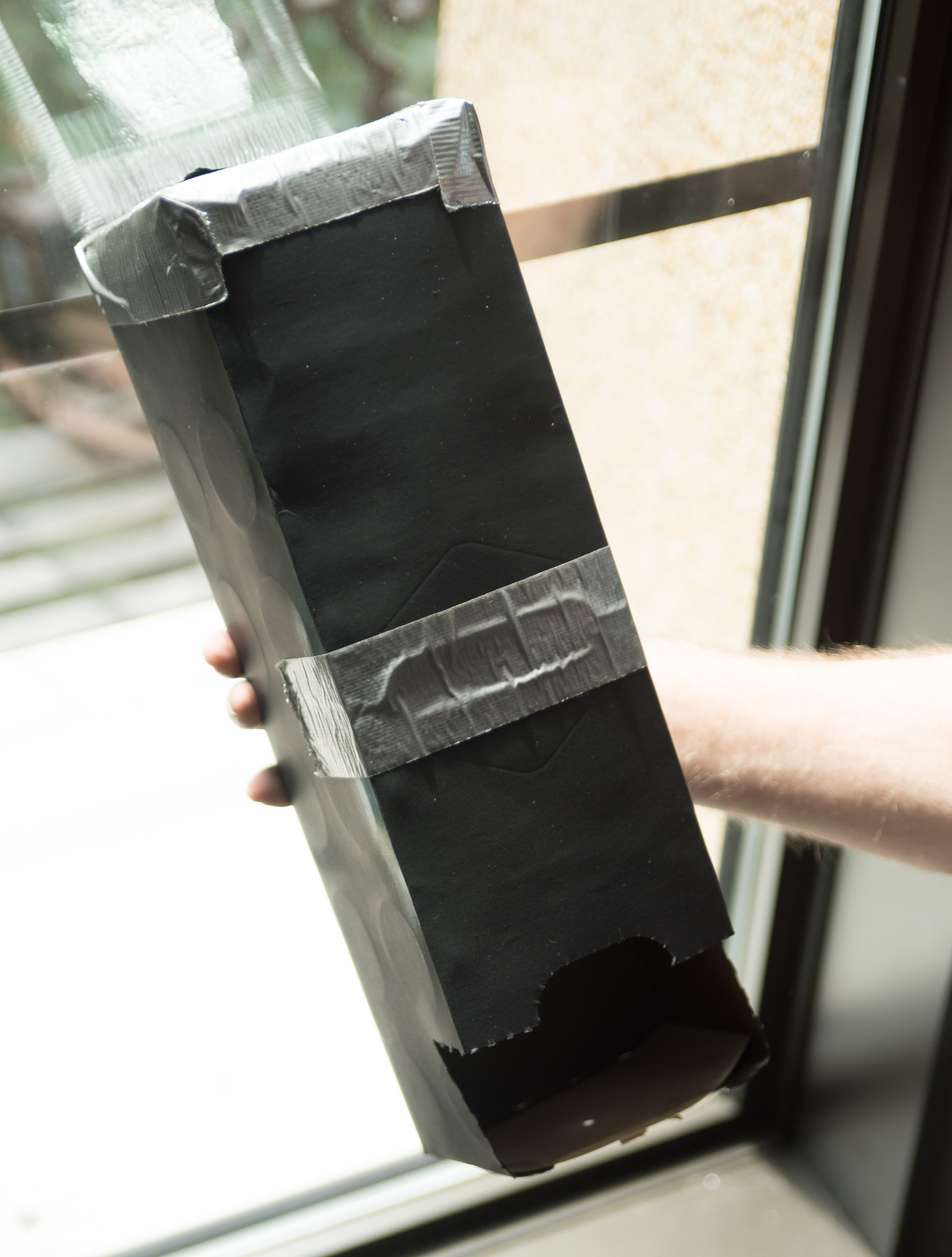 Lift the viewer so that the bottom is at eye level. The aluminum foil should be pointed toward the sun. Align the shadow so that the disk of the sun is visible in the viewer.