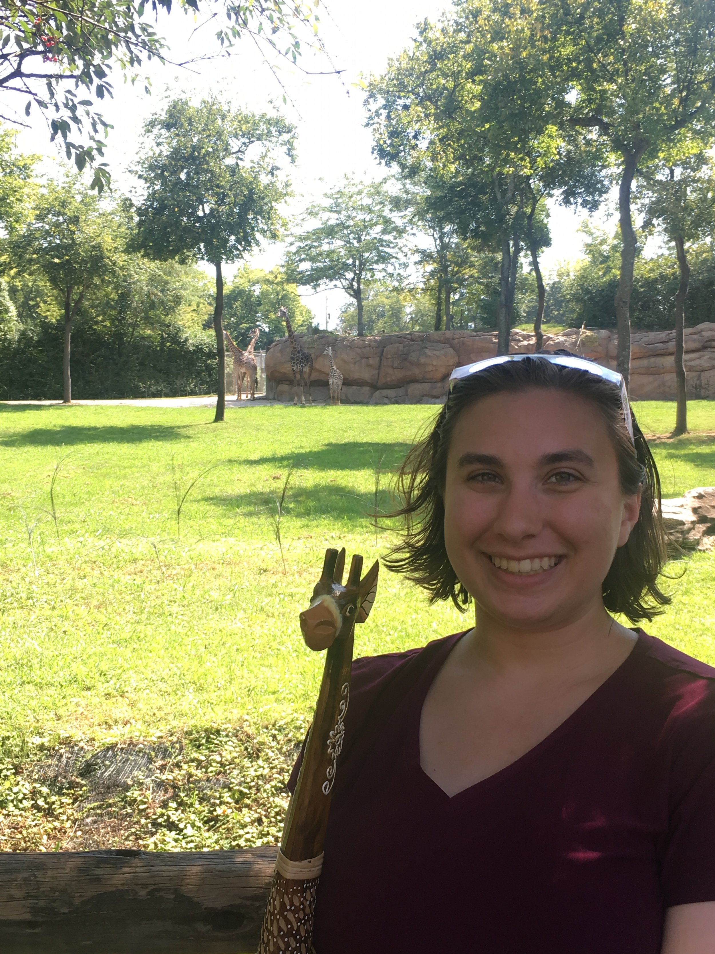 Katie Nugent with the wooden giraffe she got from the Zoo while observing the total solar eclipse 2017.